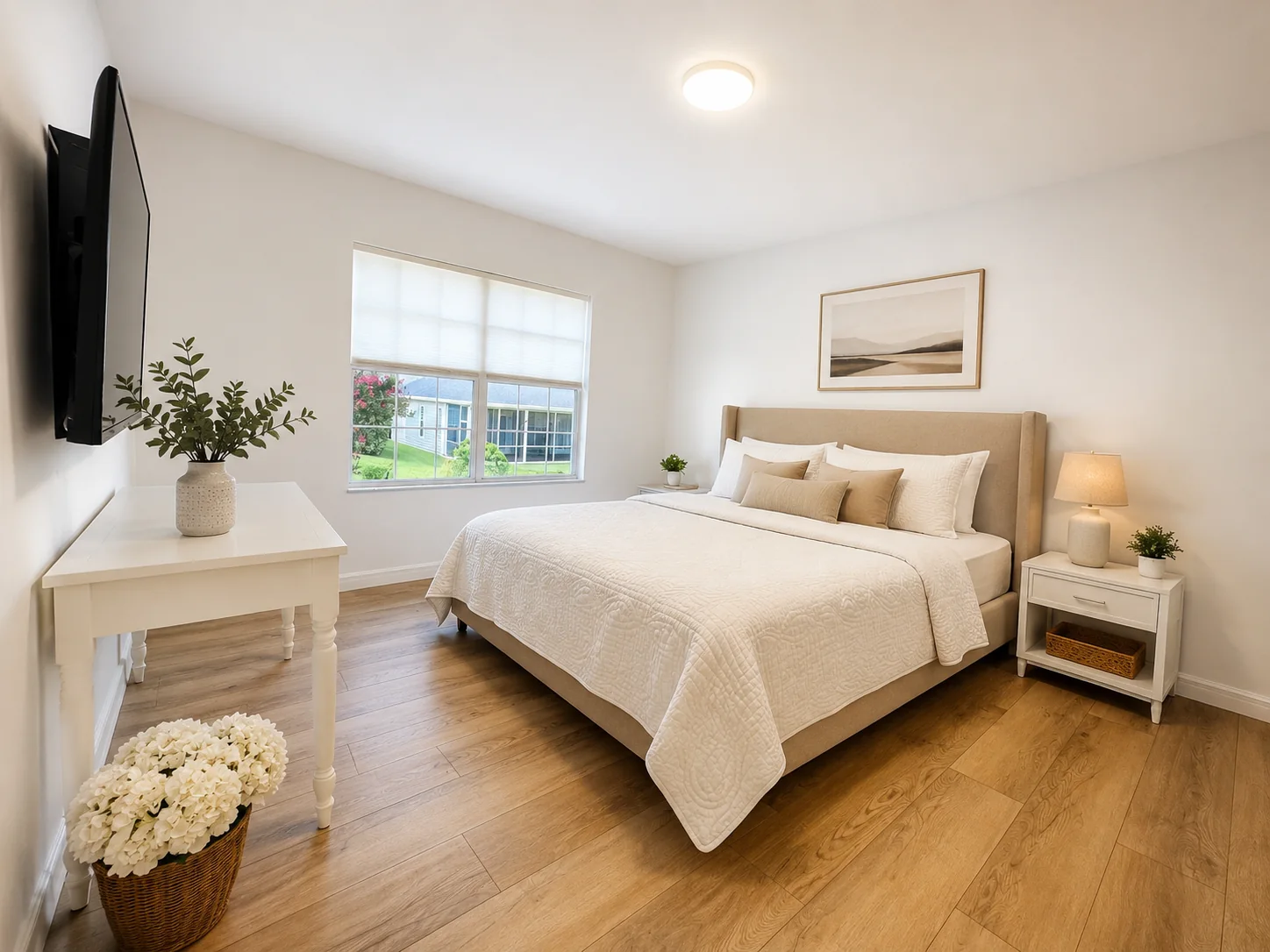 Bright primary bedroom with LVP flooring